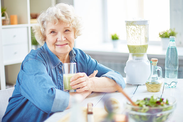 older adult enjoys a healthy smoothie at home