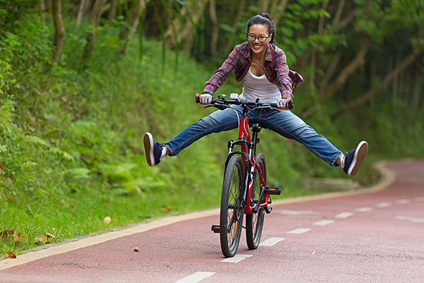 woman enjoys a bike ride outdoors