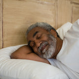 Elderly man sleeping in bed - looks happy.