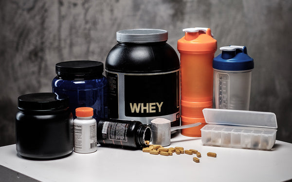 various types of workout supplements displayed on a countertop 