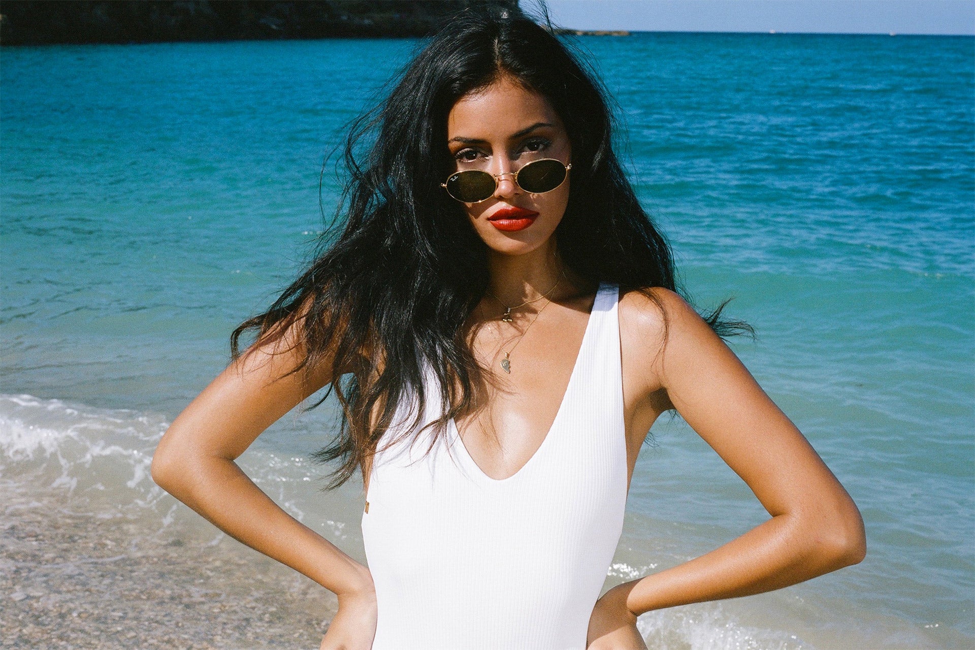 Cindy Kimberly wearing the Resort One Piece in Whipped Cream at the beach