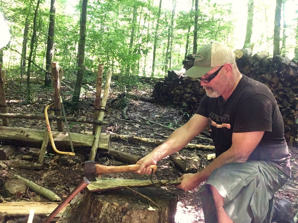 Backyard bushcraft chopping wood on a stump.