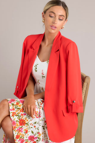 Cherry red blazer and an ivory floral midi dress.