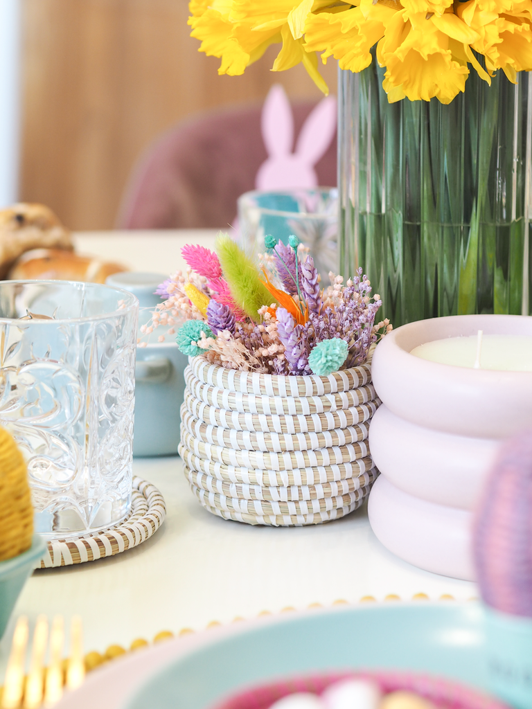 mini woven baskets with dried flowers on an easter table setting