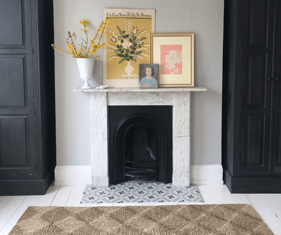 Lisa Mehydene from edit58's fireplace featuring a woven rug, picture frames and dried flowers in a vase on the mantle