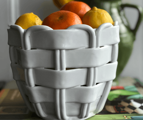 a white ceramic woven fruit bowl that looks like a basket from Sophie Douglas, founder of one off piece in her la basketry interview
