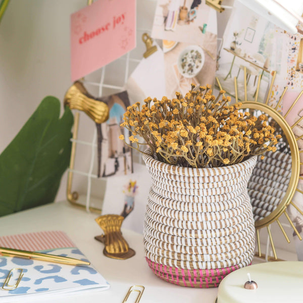 la basketry handwoven basket style woven vase in white and pink on a desk with stationery
