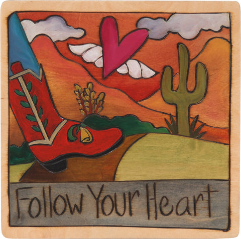 Western landscape with cowgirl boots and "follow your heart"