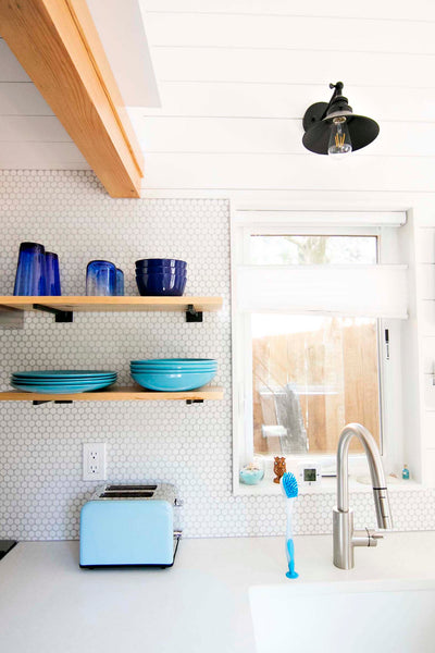 Penny tile and ship lap add a modern farmhouse vibe to the interior of this Portland Oregon tiny house.