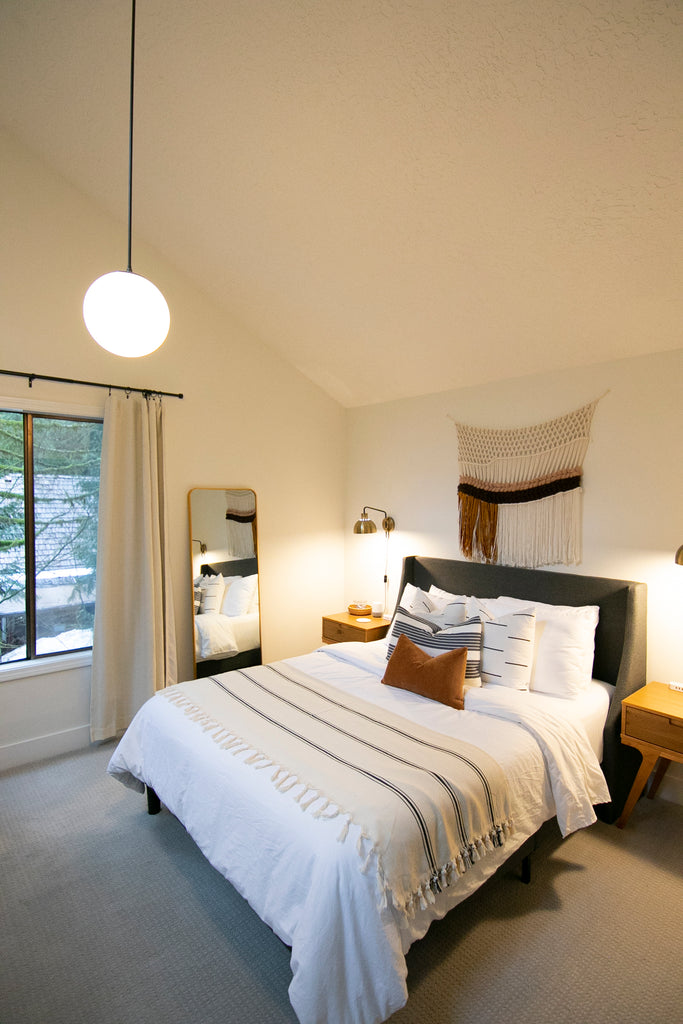 Modern primary bedroom in remodeled Mount Hood vacation rental cabin. 