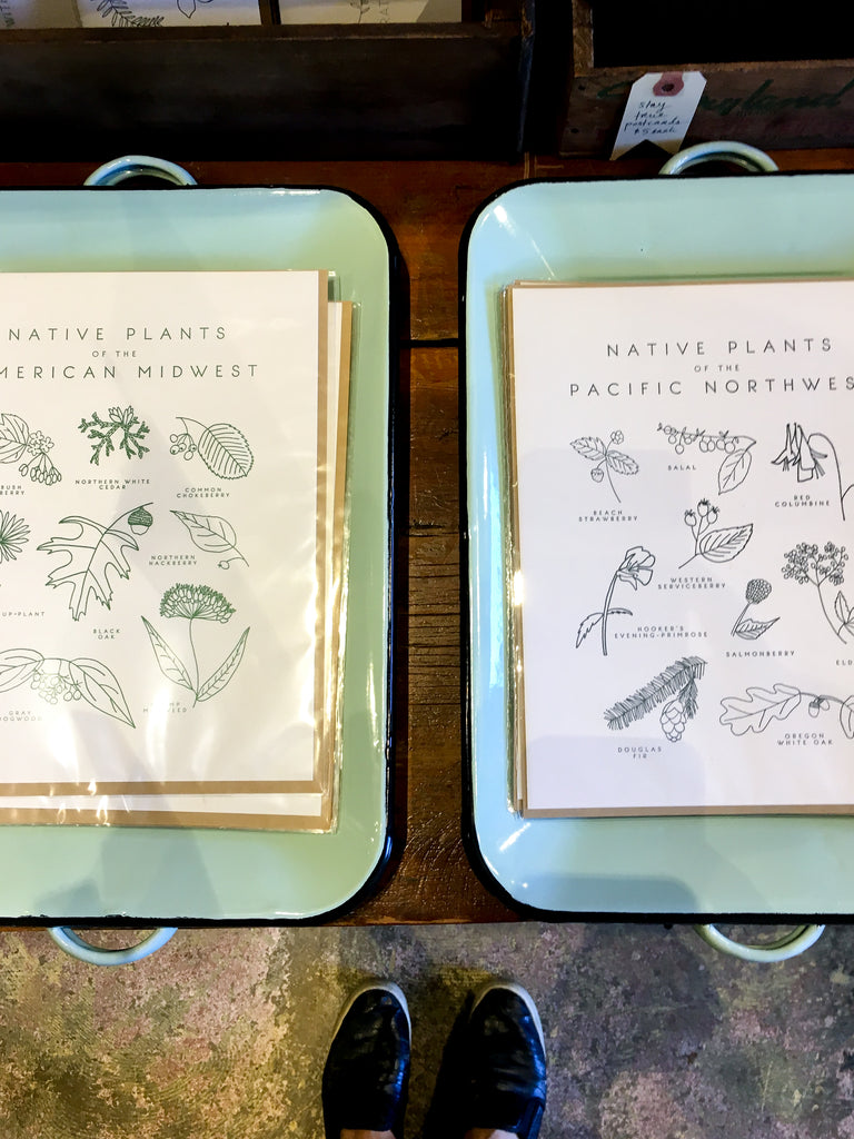 Letter Press cards sit on vintage enamel trays in a display at the boutique Porch Light in Portland, Oregon.