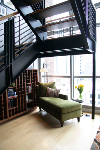 Tucking a chaise under the stairs turned an awkward space into a reading reading area with a great view