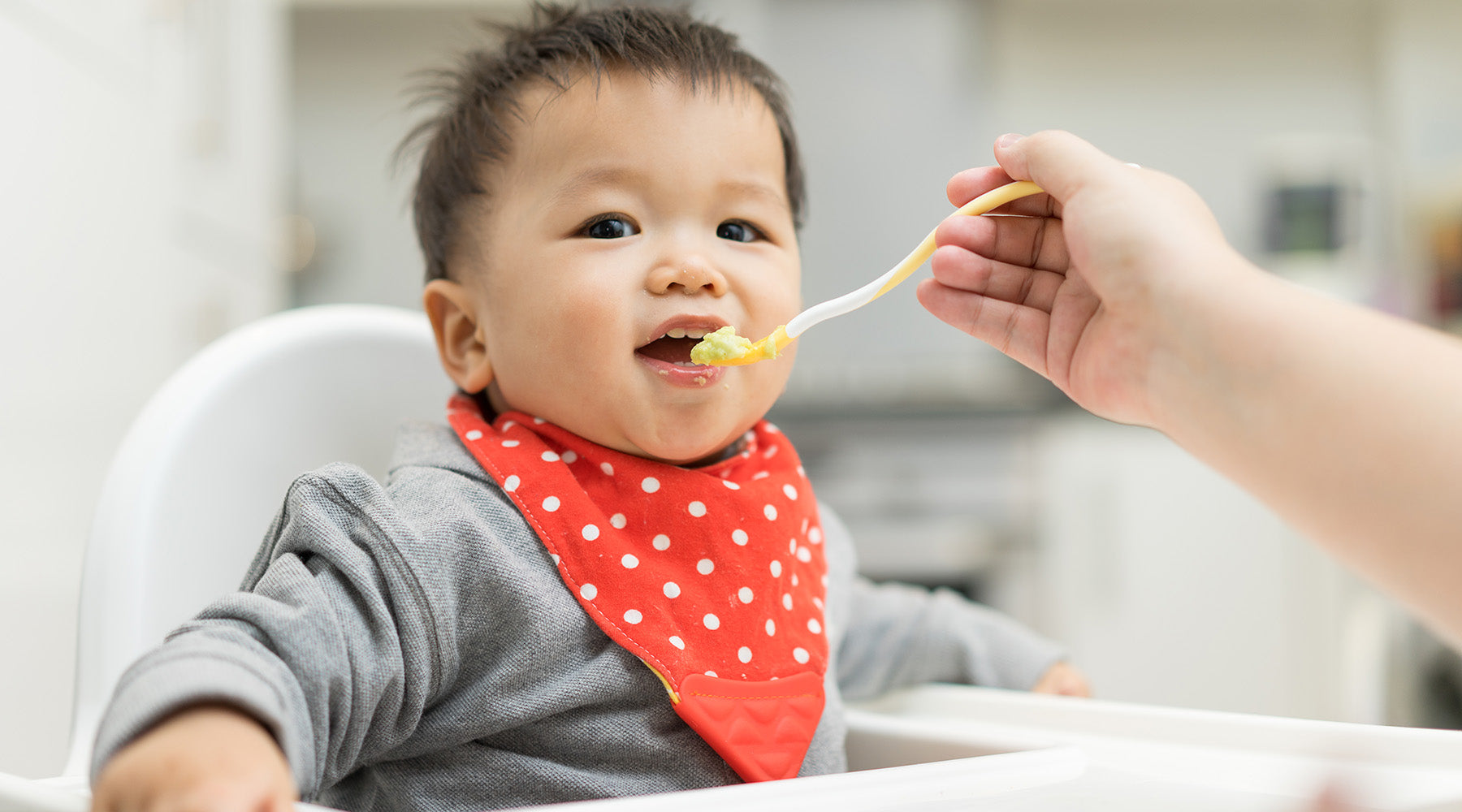 spoon feeding a baby