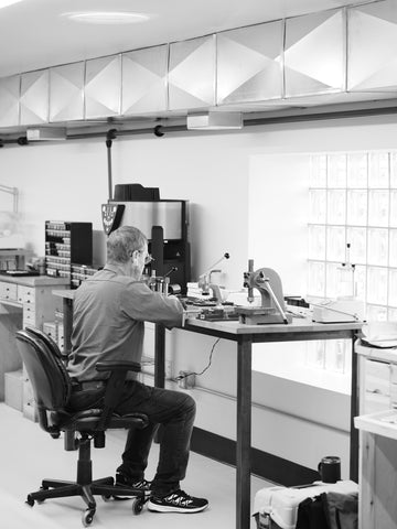 Watchmaker working in cleanroom