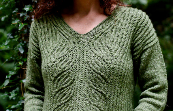 close up front detail of oa woman in a green sweater