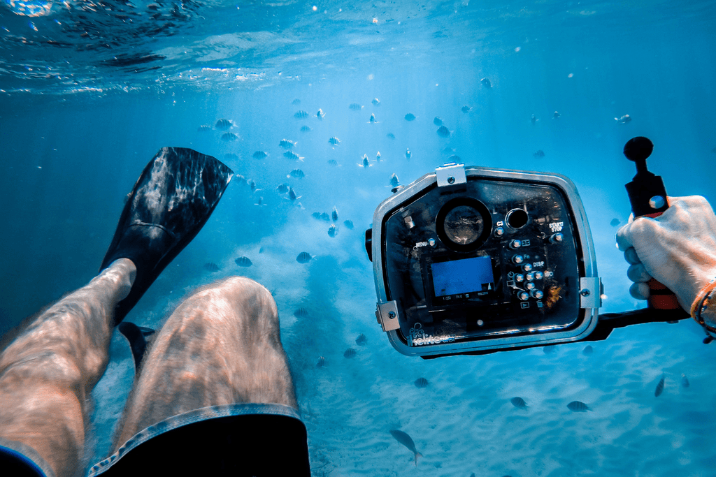 Freediving in the ocean wearing fins, mask and snorkel. Practicing to hold their breath while surrounded by beautiful coral reefs and ocean. 