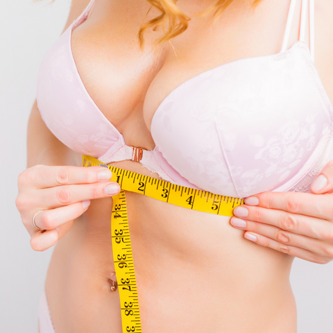 woman measuring bra size for accurate bra fit