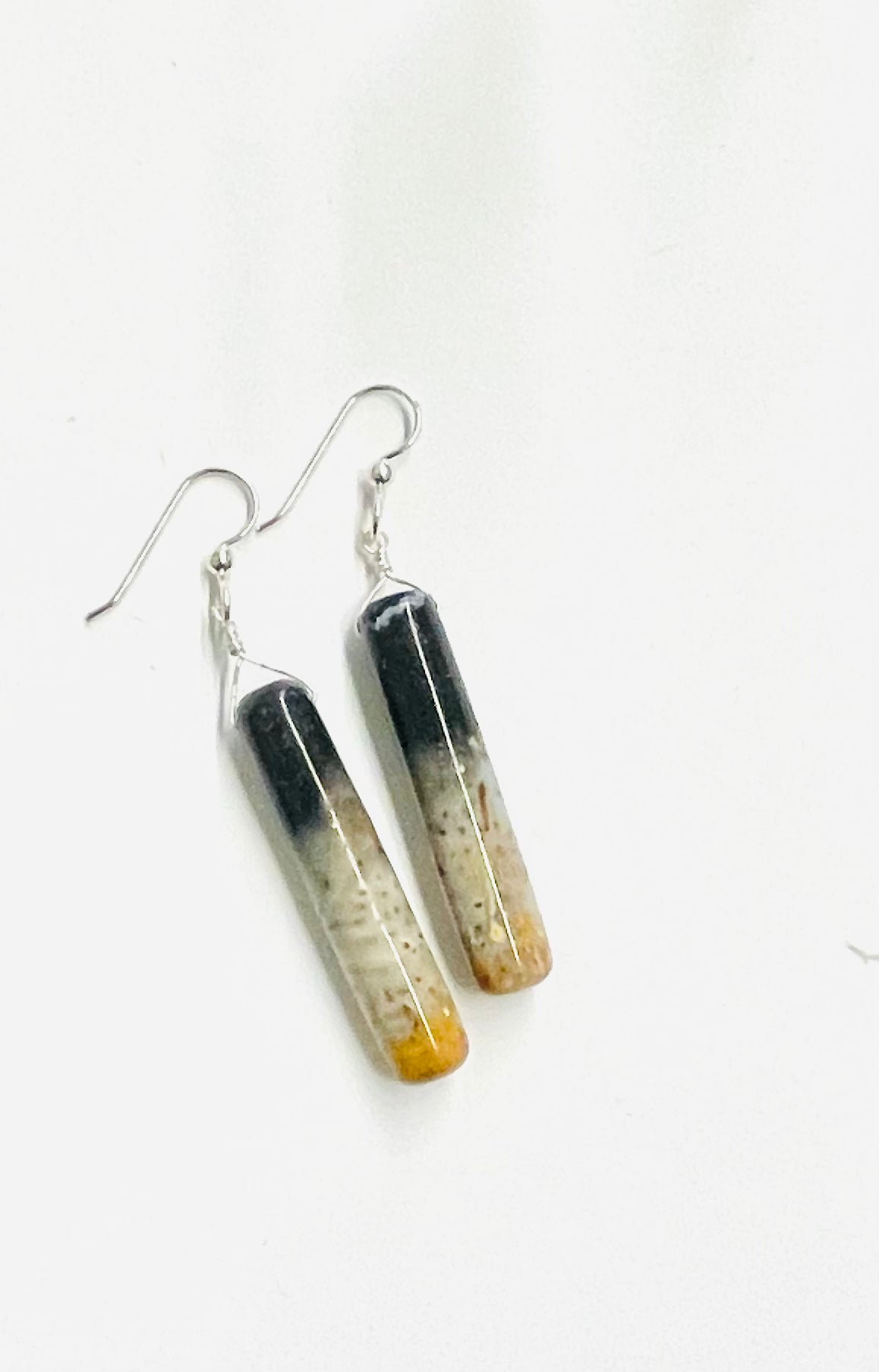 Earrings with cylinder shaped petrified palm root