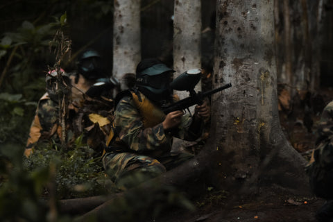 Players in an outdoor paintball game