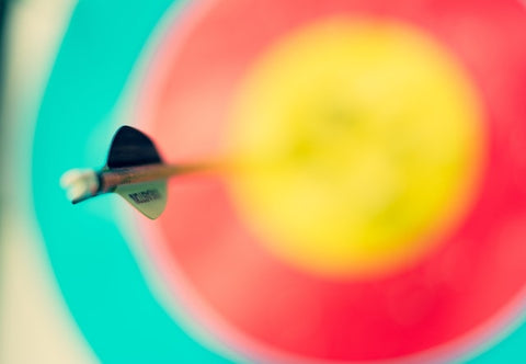 Colored target out of focus with centered dart, in focus