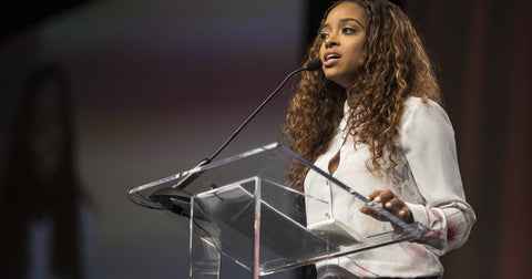 Tamika Mallory wearing bomb hair while speaking out as social justice activist 