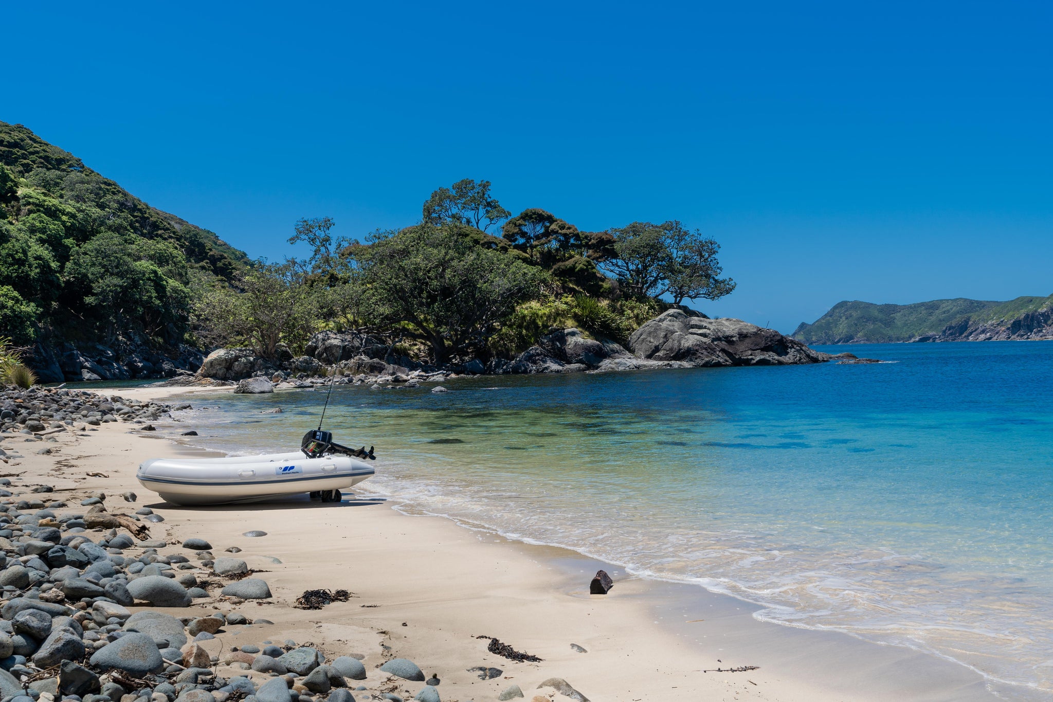 Remote beach new zealand with inflatable boat