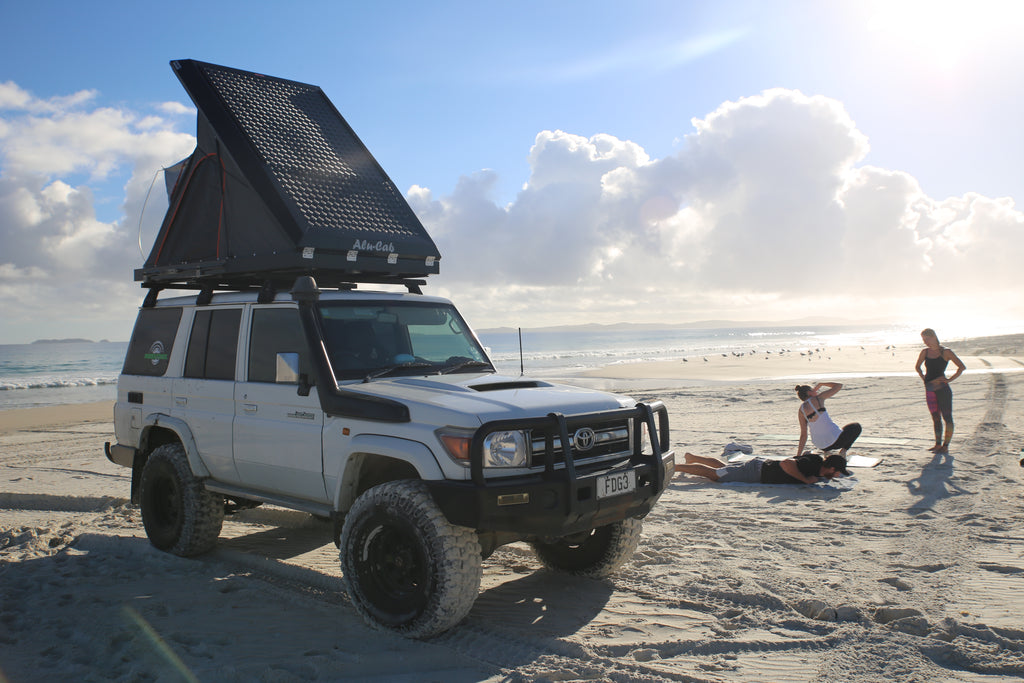 Landcruiser 76 and Alu-Cab camper facing beach