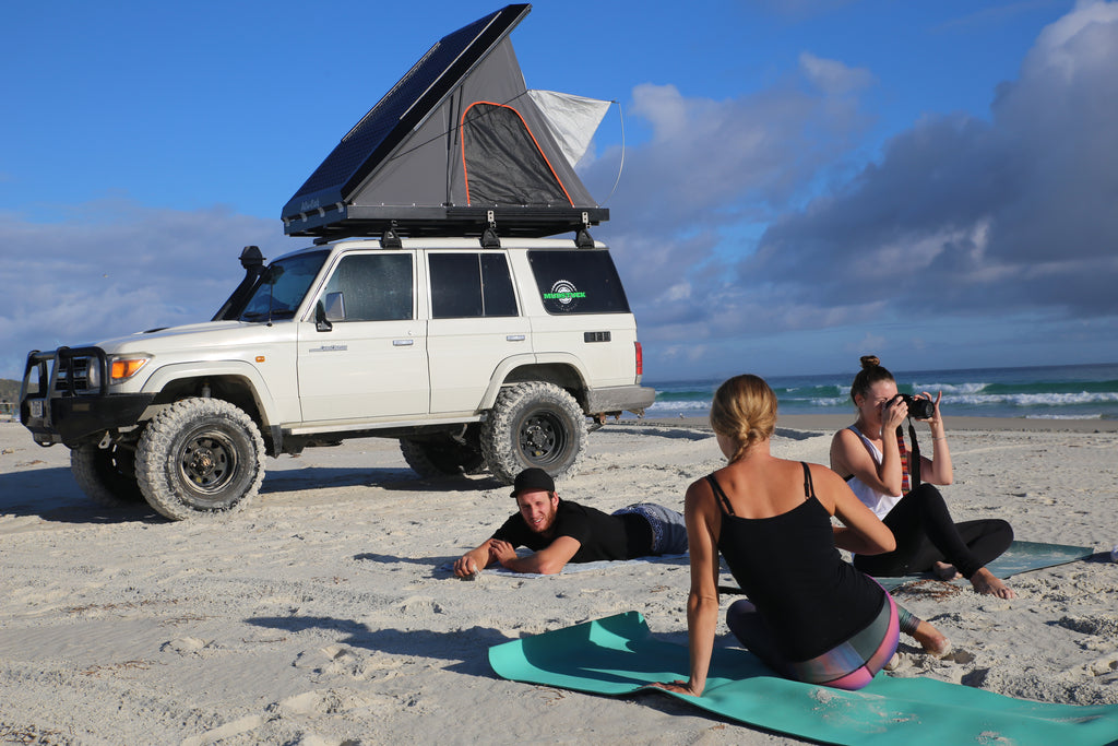 Landcruiser 76 on beach with friends and Alu-Cab