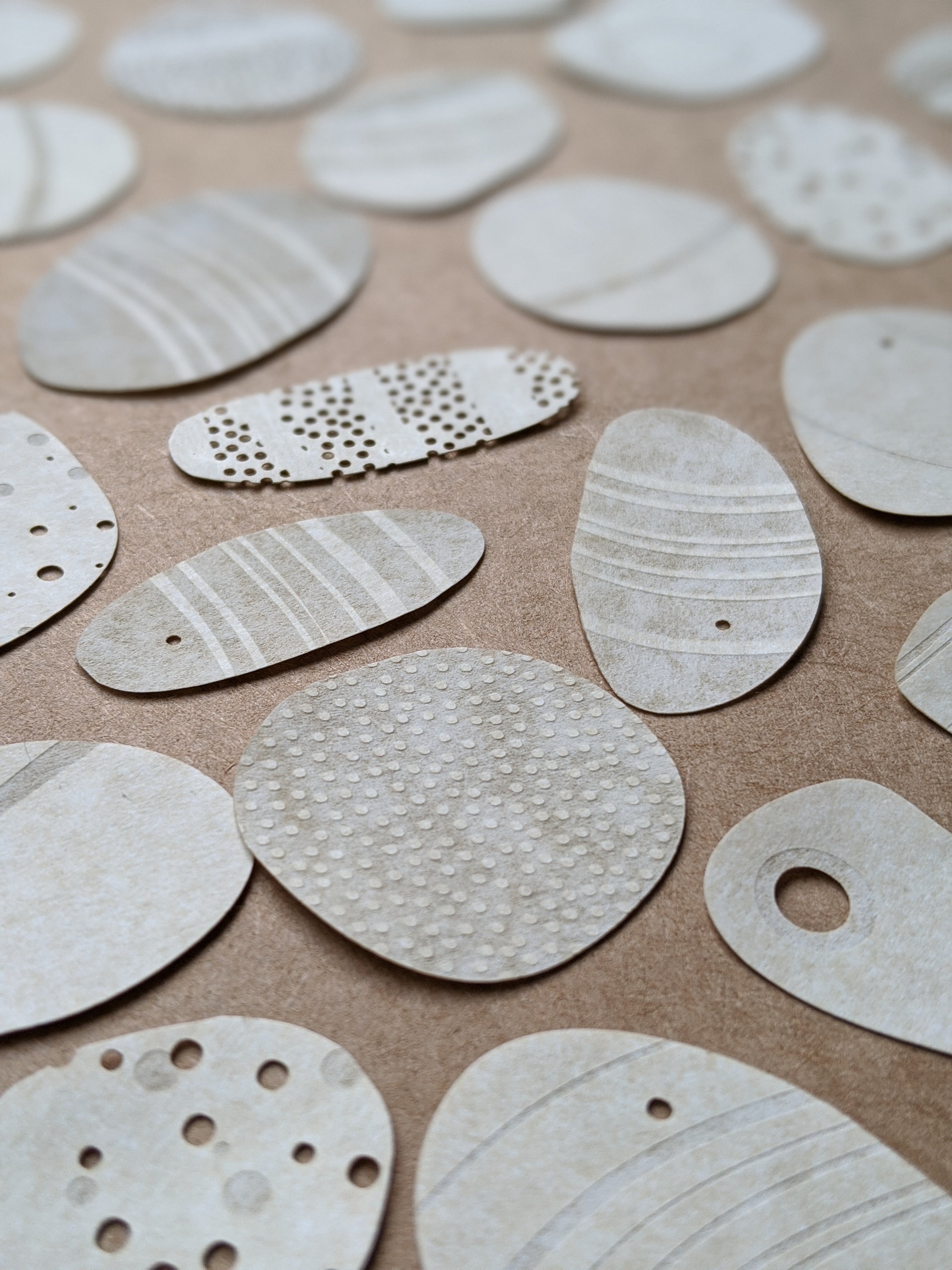 laser cut and engraved pebbles by Hannah Nunn