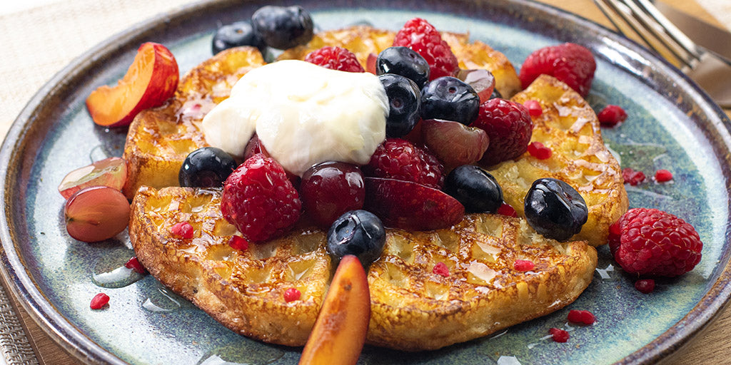 Lo-Dough waffles with mixed berries, yoghurt and syrup on top 