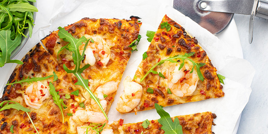 Low carb prawn and chilli Lo-Dough pizza with a slice cut out