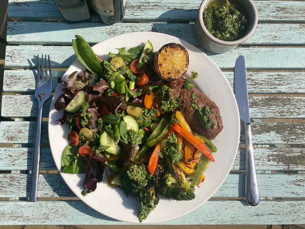 barbecue lamb with mixed vegetables and wild garlic sauce on a plate