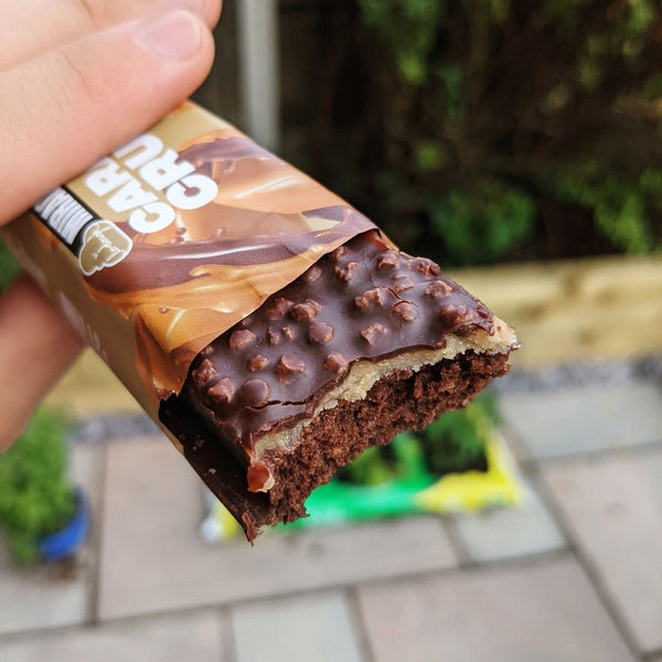 Lo-Dough caramel crunch miracle cake bar with a bite out 