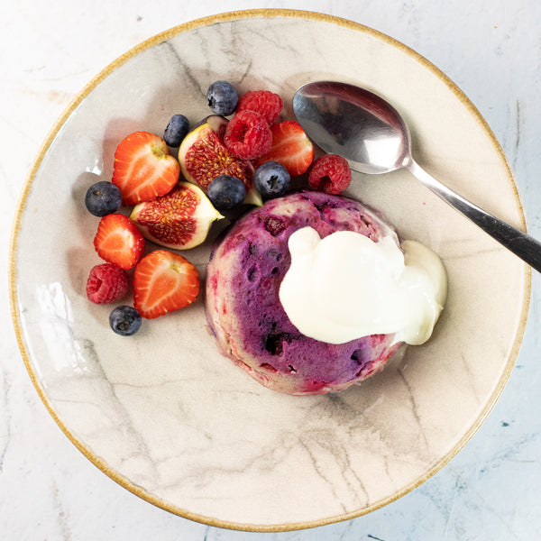 Healthy mixed fruit mug cake with fruit and yoghurt in a bowl