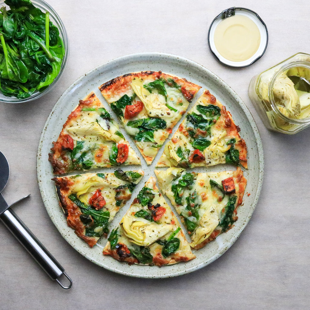 Artichoke and Spinach Pizza with pizza cutter