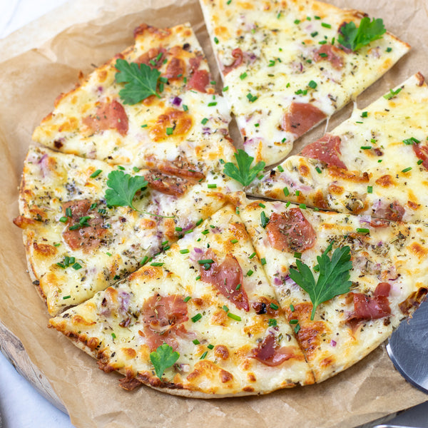 Protein cheese and ham Lo-Dough pizza on crumpled brown paper 