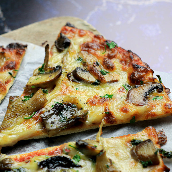 garlic mushroom Lo-Dough pizza slice on a black marble background