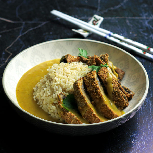 Lo-Dough vegetarian katsu curry with breaded mushrooms and rice in a light bowl