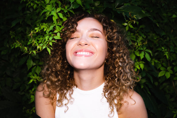 Woman smiling with curly hair