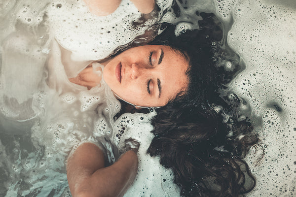 Woman washing hair with natural shampoo