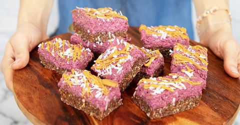 Nature Restore Acai Powder Recipe for Healthy Diet - DIY power bars with peanut butter drizzle on wood tray