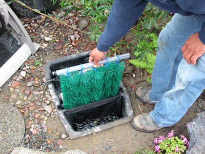 Hydro Clean pond skimmers' filter brush rack handle is above the water line