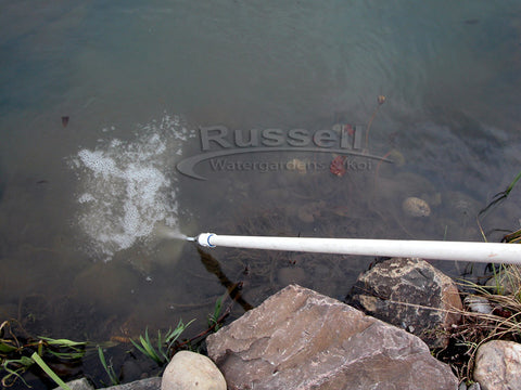 Fluffing the gravel in a water garden pond keeps it clean.