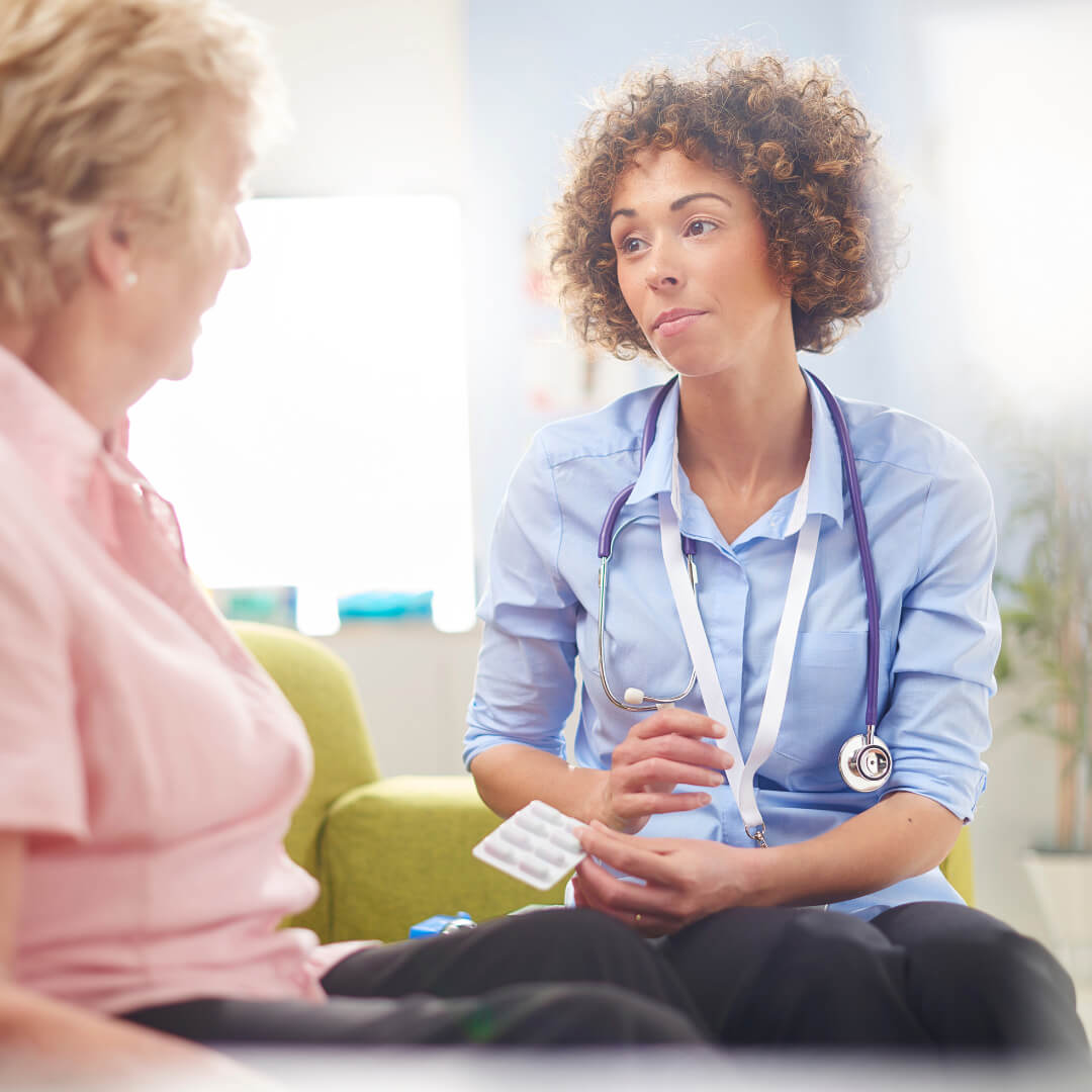 Older woman talking to female GP