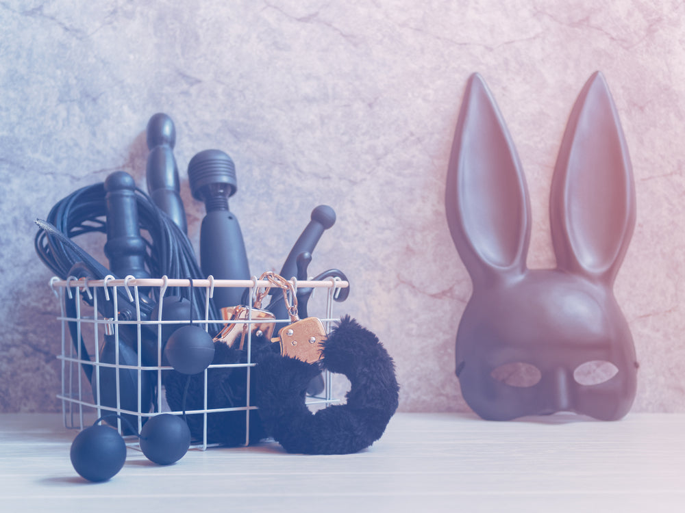 Different types of sex toys in a metal basket