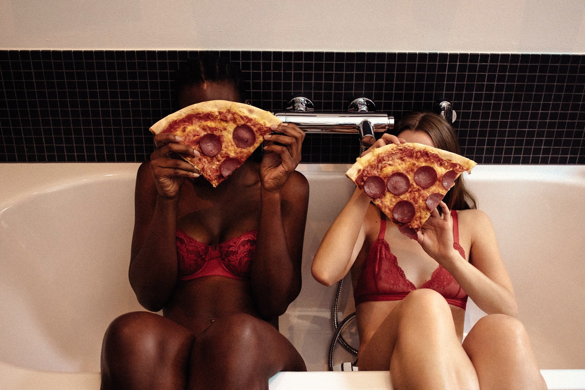 two girls eating pizza