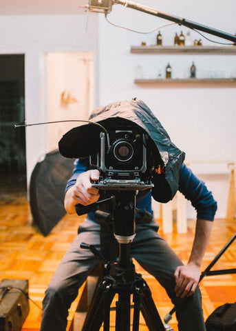 Rodrigo taking a photograph standing behind a camera