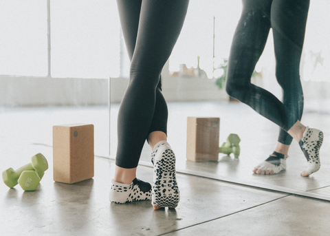 yoga essentials including grip socks, weights, and yoga block