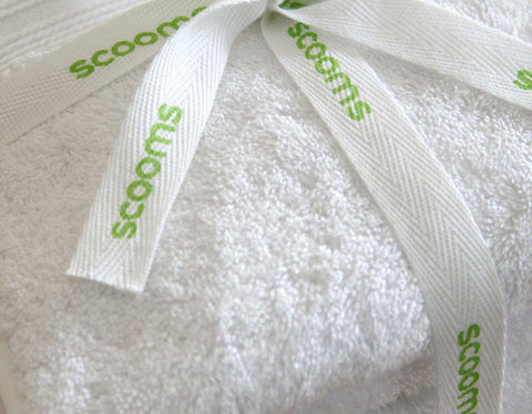 Egyptian cotton bath towel in white tied with scooms ribbon