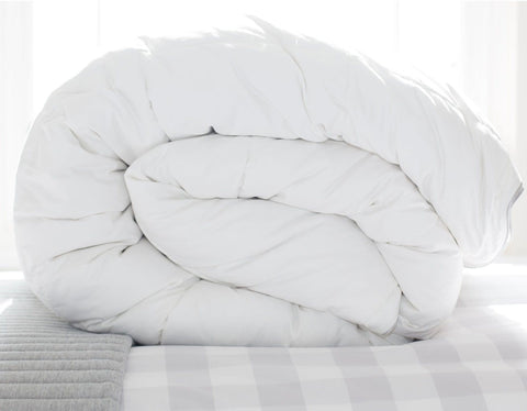 Rolled Hungarian Goose Down duvet on a bed